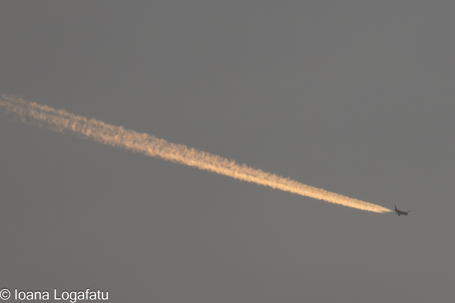 Beautiful sunset sky with a jet trail glimmering